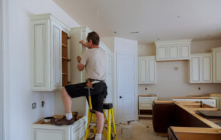 Man installing kitchen cabinets door installation of kitchen cabinet door replacement cost